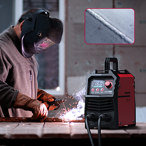 Welder using an arc welder with protective gear during welding