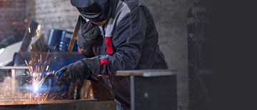 Welder welding metal with sparks during a welding project